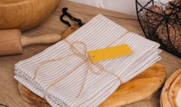 white and gray stripe towels on brown wooden chopping board