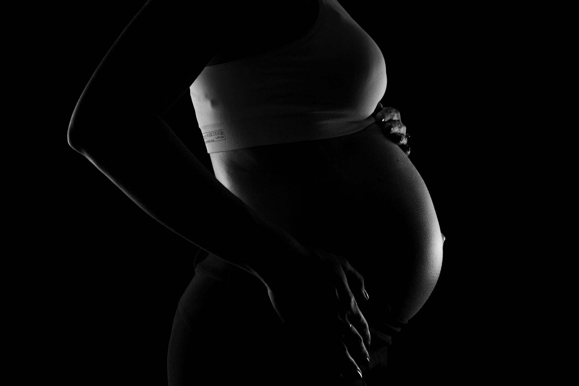 gray scale photo of a pregnant woman
